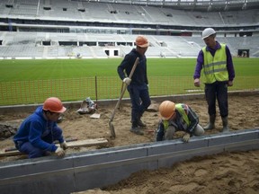 Workers at the Luzhniki stadium, which is undergoing a major rebuild to be ready to host the 2018 World Cup final, in Moscow, Russia.