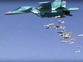 In this image made from video provided by Russian Defence Ministry press service on Aug. 18, 2016, a Russian  Su-34 unloads its bombs over a target in Syria.