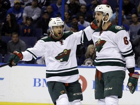 FILE - In this April 24, 2015, file photo, Minnesota Wild's Jason Pominville, left, congratulates teammate Marco Scandella after he scored during the first period in Game 5 of an NHL hockey first-round playoff series against the St. Louis Blues, in St. Louis. Former Sabres captain Jason Pominville is returning to Buffalo after being acquired along with defenseman Marco Scandella in a four-player trade with the Minnesota Wild, Friday, June 30, 2017. (AP Photo/Jeff Roberson, File)