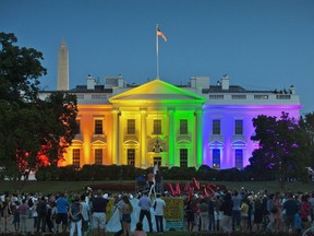 FILE - In this Friday, June 26, 2015 file photo, people gather in Washington's Lafayette Park to see the White House lit up in rainbow colors on the day the Supreme Court ruled to legalize same-sex marriage. In the two years since same-sex marriage was legalized nationwide, support for it has surged even among groups that recently were broadly opposed, according to a new national survey released on Monday, June 26, 2017. (AP Photo/Pablo Martinez Monsivais)