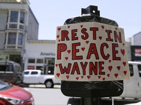 A makeshift memorial for UPS driver and shooting victim Wayne Chan is seen on Haight Street, Monday, June 19, 2017, in San Francisco. A San Francisco man wounded in a shooting at a UPS warehouse that left four dead was on crutches Monday and still struggling to figure out why a fellow driver brought a gun to work last week and shot dead three drivers, including Chan. (AP Photo/Eric Risberg)