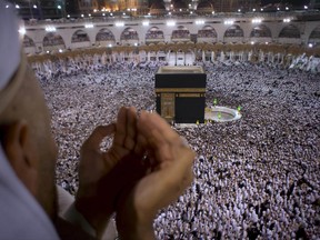 A Muslim worshipper prays during Laylat al-Qadr, Night of Decree, on the 27th day of the holy fasting month of Ramadan as pilgrims circumambulate around the Kaaba, the cubic building at the Grand Mosque, during the minor pilgrimage, known as Umrah, in the Muslim holy city of Mecca, Saudi Arabia, early Thursday, June 22, 2017. Laylat al-Qadr, is the night Muslims commemorate the revelation of the first verses of the Quran to their Prophet Muhammad through the angel Gabriel. (AP Photo/Amr Nabil)