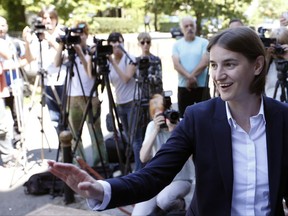 FILE  - In this Friday, June 16, 2017 file photo, Ana Brnabic, nominated as the prime minister-designate arrives at the municipality building and waves to her supporters in Vrnjacka Banja, Serbia. Serbia's first openly gay and female prime minister is set to take office in the staunchly conservative country next week after the ruling populists mustered majority support for her in parliament. Officials said on Friday, June 23, 2017 that the assembly will convene on Saturday to start the proceedings for the election of Ana Brnabic and her government.﻿ (AP Photo/Darko Vojinovic, File)