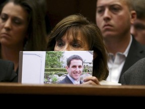 Rose Friedland holds a picture of her son Dustin Friedland Monday, June 26, 2017, as Basim Henry was sentenced to life in prison plus ten years by Essex County Superior Court Judge Michael L. Ravin after he was convicted of murder, felony murder, carjacking and other charges in the death of Dustin Friedland at the Mall at Short Hills in 2013. Sentencing was in Ravin's courtroom at the Essex County Courthouse on Monday in Newark, NJ.  (Ed Murray/NJ Advance Media via AP, Pool)