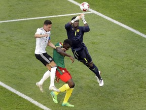 Cameroon goalkeeper Fabrice Ondoa, right, and Germany's Julian Draxler, left, challenge for the ball during the Confederations Cup, Group B soccer match between Germany and Cameroon, at the Fisht Stadium in Sochi, Russia, Sunday June 25, 2017. (AP Photo/Sergei Grits)