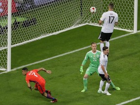 Chile's Alexis Sanchez, left, reacts after scoring during the Confederations Cup, Group B soccer match between Germany and Chile, at the Kazan Arena, Russia, Thursday, June 22, 2017. (AP Photo/Sergei Grits)