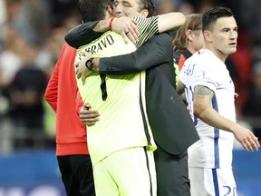 Chile goalkeeper Claudio Bravo, left, celebrates with Chile coach Juan Antonio Pizzi after winning the Confederations Cup, semifinal soccer match between Portugal and Chile, at the Kazan Arena, Russia, Wednesday, June 28, 2017. (AP Photo/Pavel Golovkin)