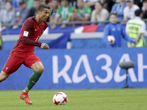 Portugal's Cristiano Ronaldo runs with the ball during the Confederations Cup, Group A soccer match between Portugal and Mexico, at the Kazan Arena, Russia, Sunday, June 18, 2017. (AP Photo/Thanassis Stavrakis)