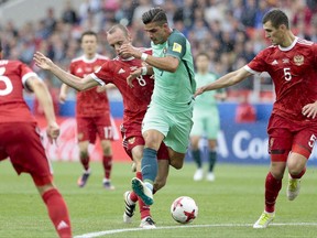 Portugal's Andre Silva is challenged by Russia's Denis Glushakov during the Confederations Cup, Group A soccer match between Russia and Portugal, at the Spartak Stadium in Moscow, Wednesday, June 21, 2017. (AP Photo/Ivan Sekretarev)