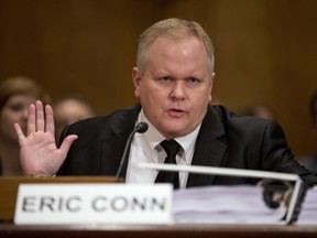 FILE - In this Oct 7, 2013 file photo, attorney Eric Conn gestures as he invokes his Fifth Amendment rights against self-incrimination during a Senate Homeland Security and Governmental Affairs committee hearing on Capitol Hill in Washington. Conn, a fugitive Kentucky lawyer at the center of a nearly $600 million Social Security fraud case, has fled the country using a fake passport and has gotten help from someone overseas with a job to help support himself, the Lexington Herald-Leader reported Sunday, June 25, 2017. (AP Photo/ Evan Vucci, File)