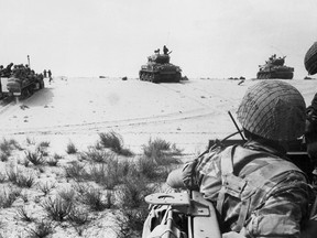 This file photo taken on June 5, 1967 shows Israeli armored forces in action in the Sinai Desert.  In six days in 1967 Egypt's vaunted airforce was destroyed and its army humbled. Egyptians never overcame the shock of that defeat to Israel that spelled the end of their country's regional dominance.