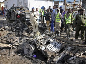 Somali security forces gather at the scene of a suicide car bomb attack on a police station in Mogadishu, Somalia Thursday, June 22, 2017. A number of people are dead and several others wounded in the blast in Somalia's capital, police said Thursday, adding that the bomber was trying to drive into the police station's gate but detonated against the wall instead. (AP Photo/Farah Abdi Warsameh)