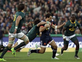 France's Kevin Gourdon, front, is tackled behind by South Africa's Jan Serfontein during the international rugby union test match between South Africa and France, at Ellis Park stadium in Johannesburg, South Africa, Saturday, June 24, 2017. (AP Photo/Themba Hadebe)
