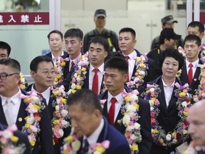 North Korean taekwondo demonstration team members and other officials arrive at Gimpo International Airport in Seoul, South Korea, Friday, June 23, 2017. The team has arrived in South Korea for its first performances in the rival country in 10 years. (AP Photo/Lee Jin-man)