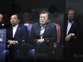 South Korean President Moon Jae-in, second from right, watches a test launch of the Hyunmoo-2 missile at the Agency for Defense Development in Anheung, South Korea, Friday, June 23, 2017. Moon observed the test-firing of a new midrange missile the country is developing to cope with growing threats from North Korea. (Yonhap via AP)