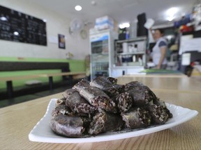 In this Tuesday, June 20, 2017, photo, a plate of North Korean blood sausages sits on a table at Howol-ilga, a restaurant in Incheon, South Korea. Outside Seoul, a tiny restaurant whose Korean name means "People from Different Homelands Come to Gather in One Place" attracts patrons from across the country serving up potato pancakes, blood sausage, and memories of North Korea – the outcast homeland those patrons may never see again. (AP Photo/Ahn Young-joon)