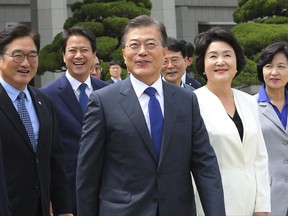 South Korean President Moon Jae-in, center, arrives to leave for the United States at the Seoul military airport in Seongnam, South Korea, Wednesday, June 28, 2017. Moon left for the United States for a summit meeting with his U.S. counterpart Donald Trump to discus the controversial U.S. missile defense system and North Korea's nuclear issues. (AP Photo/Ahn Young-joon)