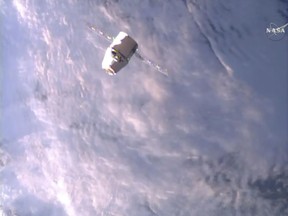 A SpaceX Dragon approaches the International Space Station on Monday, June 5, 2017, making an unprecedented second trip to the orbiting outpost. The Dragon supply ship, recycled following a 2014 flight, was launched from Florida on Saturday. (NASA TV via AP)