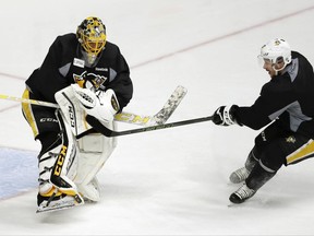 FILE - In a Sunday, June 4, 2017, file photo, Pittsburgh Penguins goalie Marc-Andre Fleury, left, blocks a shot by center Sidney Crosby during a practice, in Nashville, Tenn. Three-time Stanley Cup champion goalie Fleury, Nashville forward James Neal and Anaheim defenseman Sami Vatanen are among the high-profile players available for the Vegas Golden Knights to select in the NHL expansion draft on Wednesday, June 21, 2017.  (AP Photo/Mark Humphrey, File)