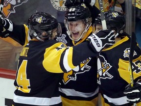 Jake Guentzel, centre, celebrates his goal against the Nashville Predators with Penguins teammates Chris Kunitz, left, and Conor Sheary during the first period in Game 2 of the Stanley Cup final on Wednesday night in Pittsburgh.