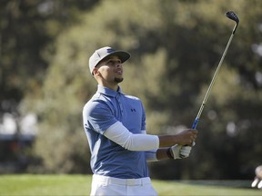 FILE - In this Oct. 12, 2016, file photo, Golden State Warriors' Stephen Curry follows his shot from the 14th fairway of the Silverado Resort North Course during the pro-am event of the Safeway Open PGA golf tournament, in Napa, Calif. Two-time NBA MVP Stephen Curry is set to test his golf game against the pros. The Web.com Tour announced Wednesday, June 28, 2017,  that Curry, who recently won his second NBA championship with the Golden State Warriors, will play in the Ellie Mae Classic. The event at TPC Stonebrae runs from Aug. 3-6.(AP Photo/Eric Risberg)