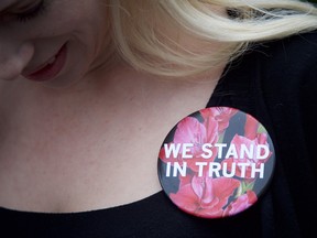 Caroline Heldman wears a pin in support of the Bill Cosby accusers outside the Montgomery County Courthouse on the opening day of the sexual assault trial June 5, 2017 in Norristown, Pennsylvania.