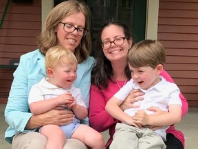 In this undated photo provided by Jana and Leigh Jacobs, the Jacobses pose with their sons Finch, left, and Yogi. The couple challenged an Arkansas birth-certificate policy that defined parents by gender. The U.S. Supreme Court rejected the policy Monday, June 26, 2017. (Jeanne Wilson photo/ provided by Jana and Leigh Jacobs via AP)