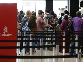 Travelers wait in line near an Emirates ticket counter at the Seattle-Tacoma International Airport, Monday, June 26, 2017, in Seattle. The U.S. Supreme Court said Monday that President Donald Trump's travel ban on visitors from Iran, Libya, Somalia, Sudan, Syria and Yemen can be enforced if those visitors lack a "credible claim of a bona fide relationship with a person or entity in the United States," and that justices will hear full arguments in October 2017. (AP Photo/Ted S. Warren)