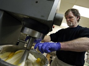 FILE - In this March 10, 2014 file photo, Masterpiece Cakeshop owner Jack Phillips cracks eggs into a cake batter mixer inside his store in Lakewood, Colo. The Supreme Court is taking on a new clash between gay rights and religion in a case about a wedding cake for a same-sex couple in Colorado. The justices said Monday, June 26, 2017, they will consider whether a baker who objects to same-sex marriage on religious grounds can refuse to make a wedding cake for a gay couple.  (AP Photo/Brennan Linsley, File)