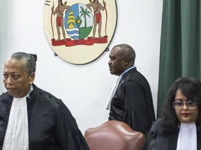 Prosecutor Roy Elgin, center, and judges Cynthia Valstein-Montnor, left, and Rewita Chatterpal, take their seats at a court in Paramaribo, Suriname, Wednesday, June 28, 2017. Elgin is calling for a 20-year prison sentence for Suriname President Desi Bouterse for his role in the December 1982 killing of 15 prominent political opponents in the South American country. (AP Photo/Pieter Van Maele)