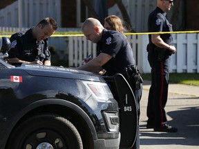 Edmonton police secure the scene of a 17-year-old boy's murder at the Parkridge Estates in the city's east end