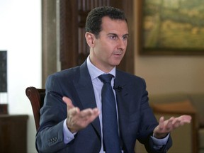 FILE -In this Wednesday, Sept. 21, 2016 file photo released by the Syrian Presidency, Syrian President Bashar Assad speaks to The Associated Press at the presidential palace in Damascus, Syria. The Syrian government on Tuesday, June 27, 2017 dismissed White House allegations that it was preparing a new chemical weapons attack, as activists reported an airstrike on an Islamic State-run jail in eastern Syria that they said killed more than 40 prisoners. (Syrian Presidency via AP, File)