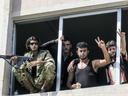 Free Syrian Army fighters give the victory sign, in Jarablus, Syria.