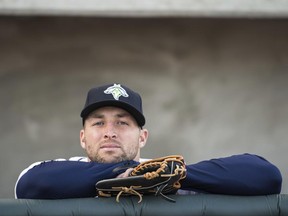 FILE- In this April 6, 2017, file photo, Columbia Fireflies outfielder Tim Tebow looks out from the dugout before the team's minor league baseball game against the Augusta GreenJackets in Columbia, S.C. Tebow has been promoted to the New York Mets' high Class A affiliate in St. Lucie, Fla. General manager Sandy Alderson announced the move before the Mets' 8-2 win at San Francisco on Sunday, June 25. (AP Photo/Sean Rayford, File)