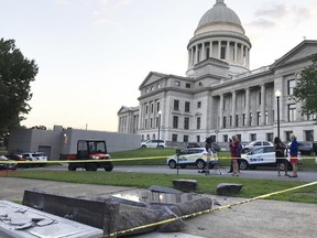 The new Ten Commandments monument outside the state Capitol in Little Rock, Ark., is blocked off Wednesday morning, June 28, 2017, after someone crashed into it with a vehicle, less than 24 hours after the privately funded monument was placed on the Capitol grounds. Authorities arrested a male suspect. (AP Photo/Jill Zeman Bleed)