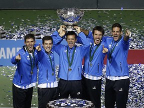 File - This is a Sunday, Nov. 27, 2016 file photo of Argentina's team as they lift the Davis Cup trophy after winning the final against Croatia in Zagreb, Croatia. The Davis Cup and Fed Cup are planning to combine forces into a World Cup of Tennis. A three-year deal starting in 2018 to combine the events was announced Wednesday June 28, 2017, by the International Tennis Federation. The changes still need to be approved at the federation's annual general meeting in August in Vietnam. (AP Photo/Darko Bandic/File)