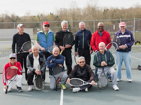 The Dunbar Irregulars gather for a group shot on a tennis court in Vancouver
