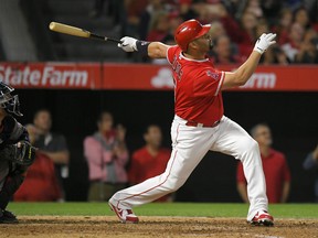 Albert Pujols of the Angels  follows through on a grand slam home run, the 600th homer of his career, during the fourth inning against the Minnesota Twins on Saturday night in Anaheim, Calif.