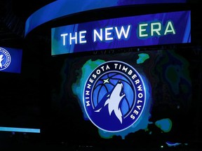 FILE - In this April 11, 2017, file photo, the new Minnesota Timberwolves logo is unveiled on the scoreboard during halftime of the team's NBA basketball game against the Oklahoma City Thunder, in Minneapolis. The Timberwolves are getting into the jersey advertisement game with a Fitbit patch in a three-year deal. The Timberwolves announced the marketing collaboration for the team's first jersey patch on Tuesday, June 20, 2017. (AP Photo/Jim Mone, File)