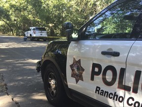 Rancho Cordova police investigate an SUV owned by a man and a woman detained for questioning, Wednesday, June 28, 2017, in Rancho Cordova, Calif. Authorities say they are investigating the death of a toddler found under some blankets in the back of an SUV parked the wrong way on a Northern California street. (Sacramento County Sheriff's Department via AP)