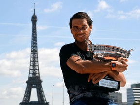 Rafael Nadal poses with the French Open trophy in Paris on June 12.