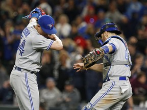 Toronto Blue Jays closer Roberto Osuna (left) dabs with catcher Russell Martin after a win over the Seattle Mariners on June 10.