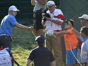 Jordan Spieth tosses a signed cap back to a fan after finishing the first round of the Travelers Championship golf tournament Thursday, June 22, 2017, in Cromwell, Conn. (Brad Horrigan/Hartford Courant via AP)