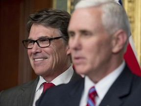 FILE- In this March 2, 2017, file photo, Vice President Mike Pence, right, speaks before administering the oath of office to Energy Secretary Rick Perry, left, in the Eisenhower Executive Office Building on the White House complex in Washington. Perry said Monday, June 26, that the Trump administration is confident officials can "pave the path toward U.S. energy dominance" by exporting oil, gas and coal to markets around the world, and promoting nuclear energy and even renewables such as wind and solar power. (AP Photo/Andrew Harnik, File)