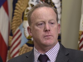 FILE - In this June 15, 2017, file photo, White House press secretary Sean Spicer waits for the start of an event in the Roosevelt Room of the White House in Washington. Spicer is seeking to take on a more strategic role within the White House that would give him a limited presence in the daily press briefings that have made him a prominent face of the Trump administration. A senior administration official and three people familiar with the potential changes said Spicer has discussed taking a more senior communications role at the White House.  (AP Photo/Susan Walsh, File)