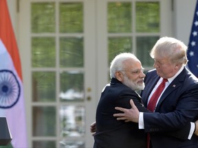 President Donald Trump and Indian Prime Minister Narendra Modi hug while making statements in the Rose Garden of the White House in Washington, Monday, June 26, 2017. (AP Photo/Susan Walsh)