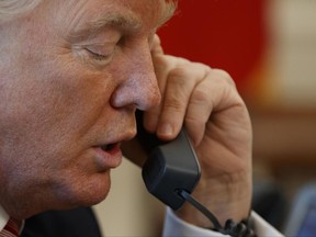 President Donald Trump speaks on the phone in a June file photo.