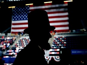 A man dressed as Abraham Lincoln walks through the crowd before the arrival of President Donald Trump at a rally, Wednesday, June 21, 2017, in Cedar Rapids, Iowa. (AP Photo/Charlie Neibergall)