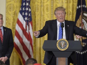 President Donald Trump, right, standing with Veterans Affairs Secretary David Shulkin, left, speaks during a bill signing event for the "Department of Veterans Affairs Accountability and Whistleblower Protection Act of 2017," in the East Room of the White House, in Washington, Friday, June 23, 2017. (AP Photo/Susan Walsh)