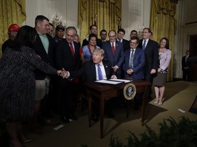 President Donald Trump shakes hands with Sarah Verardo during a signing ceremony of the "Department of Veterans Affairs Accountability and Whistleblower Protection Act of 2017" in the East Room of the White House, Friday, June 23, 2017, in Washington. (AP Photo/Evan Vucci)